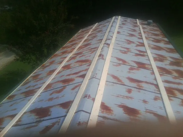Rusted metal roof panels with new wood purlins before replacement — Storm Damage Roof Repair in Moro by Roofing Brothers